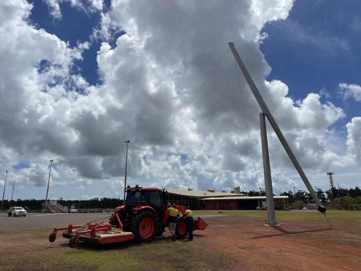 Gove Airport light tower installation - tractor and airport terminal, taxiway